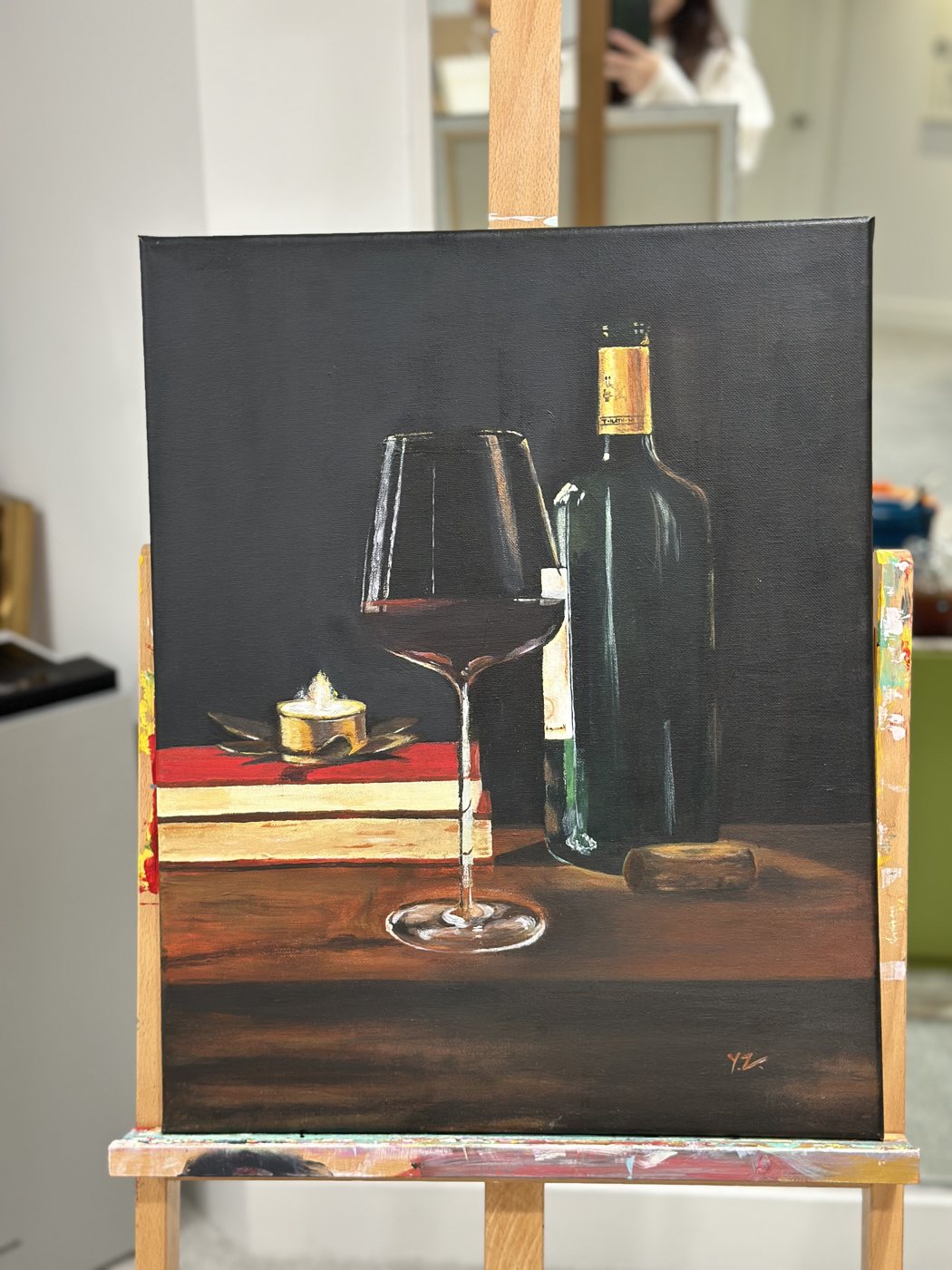 Still life of red wine, a bottle and books